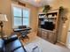 Relaxing Gathering room featuring a flatscreen TV, decorative shelving, and natural light from the window at 4213 Vicenza Dr # A2, Venice, FL 34293