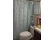 Cozy bathroom featuring a toilet and a light blue shower curtain with a seashell pattern at 469 Albee Farm Rd # V19, Venice, FL 34285