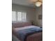 Bright bedroom featuring plantation shutters, comfortable bedding, and a cozy ambiance at 469 Albee Farm Rd # V19, Venice, FL 34285