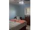 Bedroom featuring a ceiling fan, window with blinds, and red-patterned bedspread at 469 Albee Farm Rd # V19, Venice, FL 34285