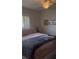 Comfortable bedroom with a queen-size bed, ceiling fan, and natural light at 469 Albee Farm Rd # V19, Venice, FL 34285