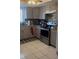 Updated kitchen featuring gray cabinets, stainless steel appliances, and granite countertops at 469 Albee Farm Rd # V19, Venice, FL 34285