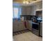 Spacious kitchen with stainless steel appliances, granite countertops, and neutral cabinets at 469 Albee Farm Rd # V19, Venice, FL 34285