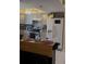 Functional kitchen with white appliances, gray cabinets, and a movable center island at 469 Albee Farm Rd # V19, Venice, FL 34285