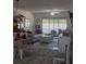 Bright living room with neutral decor, large windows, and a comfortable seating area at 469 Albee Farm Rd # V19, Venice, FL 34285