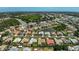 Aerial view of a residential neighborhood featuring diverse homes, a community pond, and convenient access to the main highway at 4856 Jacaranda Heights Dr, Venice, FL 34293