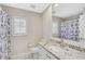 Bathroom features white cabinets, granite counters, toilet, and a shower with a cute curtain at 4856 Jacaranda Heights Dr, Venice, FL 34293
