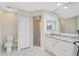 Bright bathroom features a glass shower, white cabinets, granite counters, and tiled floors at 4856 Jacaranda Heights Dr, Venice, FL 34293