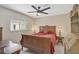 Cozy bedroom boasts a ceiling fan, a window, and vintage furniture pieces at 4856 Jacaranda Heights Dr, Venice, FL 34293