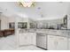 Open-concept kitchen with granite countertops, stainless steel appliances, and an eat-in bar at 4856 Jacaranda Heights Dr, Venice, FL 34293