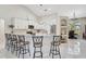 Open concept kitchen with white cabinets, granite countertops, a breakfast bar, and stainless steel appliances at 4856 Jacaranda Heights Dr, Venice, FL 34293