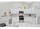 Bright kitchen with stainless steel appliances, granite countertops, and ample white cabinetry at 4856 Jacaranda Heights Dr, Venice, FL 34293
