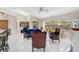Inviting living room with tile floors, stylish furniture, and large windows offering a view of the outdoors at 4856 Jacaranda Heights Dr, Venice, FL 34293