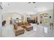 Bright living area featuring tile floors, a comfortable leather sectional sofa, and views of adjacent rooms at 4856 Jacaranda Heights Dr, Venice, FL 34293