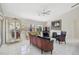 Elegant living room with tile floors, a decorative fireplace, and ample natural light at 4856 Jacaranda Heights Dr, Venice, FL 34293