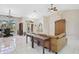 Bright living room with tile floors, vaulted ceilings, furniture, and a view to the lanai at 4856 Jacaranda Heights Dr, Venice, FL 34293