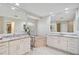 Large main bathroom featuring double vanities, granite countertops, a soaking tub, and ample mirror space at 4856 Jacaranda Heights Dr, Venice, FL 34293