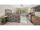 Bright main bedroom with tile floors, unique furniture, and a sliding door with views of the backyard at 4856 Jacaranda Heights Dr, Venice, FL 34293