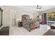 Well-lit main bedroom with tile floors, a unique bed frame, and sliding door access to the patio at 4856 Jacaranda Heights Dr, Venice, FL 34293