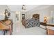 Spacious main bedroom with tile flooring, a dark wooden bed frame, and access to the main bathroom at 4856 Jacaranda Heights Dr, Venice, FL 34293