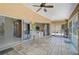 Tiled patio features sliding glass doors, an outside pinball machine, and views of the property at 4856 Jacaranda Heights Dr, Venice, FL 34293