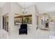 Bright sitting area with tile floors, a view of the landscaped yard, and an elegant cabinet at 4856 Jacaranda Heights Dr, Venice, FL 34293
