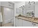 Bright bathroom features a granite countertop, white cabinetry and vanity as well as shower and tub combo at 5031 N Beach Rd # 118, Englewood, FL 34223