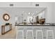 Open-concept kitchen with white bar seating, modern appliances, and a view into the dining area at 5031 N Beach Rd # 118, Englewood, FL 34223