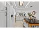 Bright kitchen with white cabinets, stainless steel appliances, tile floors and a view into the living area at 5031 N Beach Rd # 118, Englewood, FL 34223
