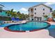 Inviting community pool with sparkling water, lounge chairs, and lush tropical landscaping creating a relaxing oasis at 5031 N Beach Rd # 118, Englewood, FL 34223