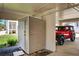 Covered parking area with storage space and a parked vehicle, offering practical solutions for storage and transportation at 5031 N Beach Rd # 118, Englewood, FL 34223