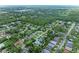 Aerial view of a neighborhood with lush green trees and well-maintained homes at 5106 S Lockwood Ridge Rd, Sarasota, FL 34231