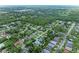 Aerial view of a neighborhood with lush green trees and well-maintained homes at 5106 S Lockwood Ridge Rd, Sarasota, FL 34231