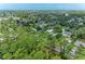 Aerial view of a house nestled amongst lush greenery and other homes at 5106 S Lockwood Ridge Rd, Sarasota, FL 34231