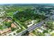 Aerial view of community near highway with a view of ponds surrounded by trees at 5106 S Lockwood Ridge Rd, Sarasota, FL 34231