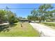 Charming single-story home with a screened porch and a well-manicured front yard at 5106 S Lockwood Ridge Rd, Sarasota, FL 34231