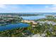 Stunning aerial view featuring lakefront property, lush greenery, city skyline and sparkling water at 525 Manatee Ct # 13, Venice, FL 34285