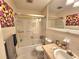 Well-lit bathroom with a shower and tub combination, vanity, and mirror at 525 Manatee Ct # 13, Venice, FL 34285