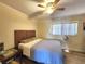 Bedroom with wood-look floors, a ceiling fan, and a woven headboard at 525 Manatee Ct # 13, Venice, FL 34285
