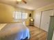 Bright bedroom with light yellow walls, wood-look flooring, and closet at 525 Manatee Ct # 13, Venice, FL 34285