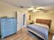 Comfortable bedroom with wood-look tile floors, a ceiling fan, and a bed at 525 Manatee Ct # 13, Venice, FL 34285