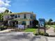 Beautful two-story museum featuring stairs to the entrance, accessible parking, a sign, and a view of the road at 525 Manatee Ct # 13, Venice, FL 34285
