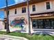 Building exterior featuring a mural and a storefront with display window at 525 Manatee Ct # 13, Venice, FL 34285