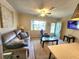 Cozy living room featuring a comfortable sofa, ceiling fan, and bright window at 525 Manatee Ct # 13, Venice, FL 34285