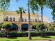 A storefront with awnings, palm trees, and wrought iron balcony at 525 Manatee Ct # 13, Venice, FL 34285