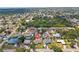 Aerial view of a neighborhood showcasing a home with a pool and mature trees at 5264 Albion Rd, Venice, FL 34293