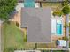 Aerial view of home showcasing the pool, landscaping, fenced backyard, and covered patio at 5264 Albion Rd, Venice, FL 34293