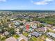 Aerial view of a neighborhood showcasing a home with a pool and mature trees at 5264 Albion Rd, Venice, FL 34293