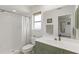 Bright bathroom with stand up shower and a white vanity with green cabinets at 5264 Albion Rd, Venice, FL 34293