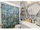 Bathroom with Jungle-themed shower curtain and tropical wallpaper at 5264 Albion Rd, Venice, FL 34293